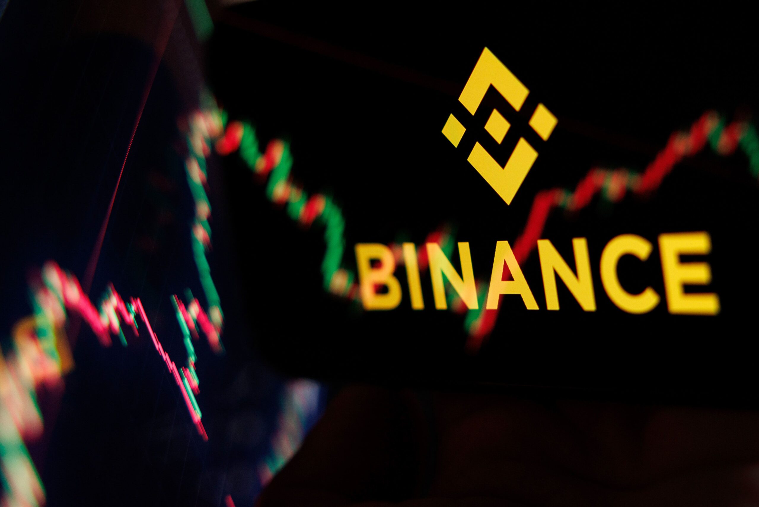 <i>Dan Kitwood/Getty Images via CNN Newsource</i><br/>The Binance logo is displayed on a phone screen adjacent to an image from a crypto exchange on a laptop on October 30 in London.