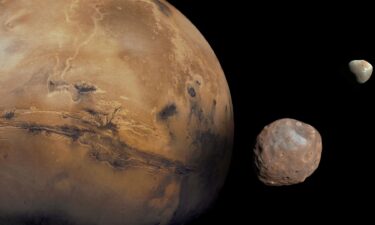 An illustration depicts the MMX spacecraft observing Phobos.