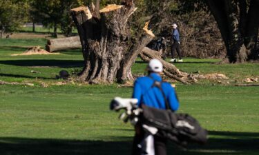 Golfers play past felled trees at East Potomac Golf Links in Washington D.C.