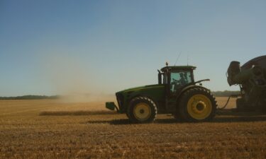 A farmer harvests wheat in Culver