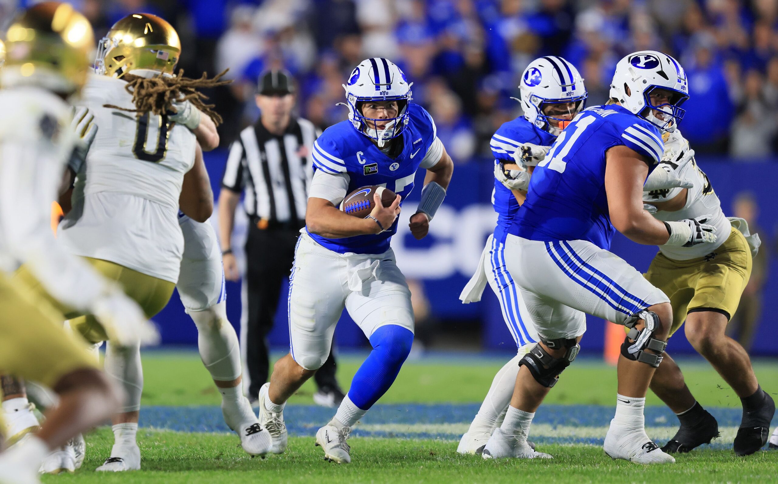 <i>Aaron Baker/Icon Sportswire/AP via CNN Newsource</i><br/>BYU Cougars fans storm the field after defeating Notre Dame during a massive primetime game last week. The win helped the Cougars move up to No. 2 in the nation.