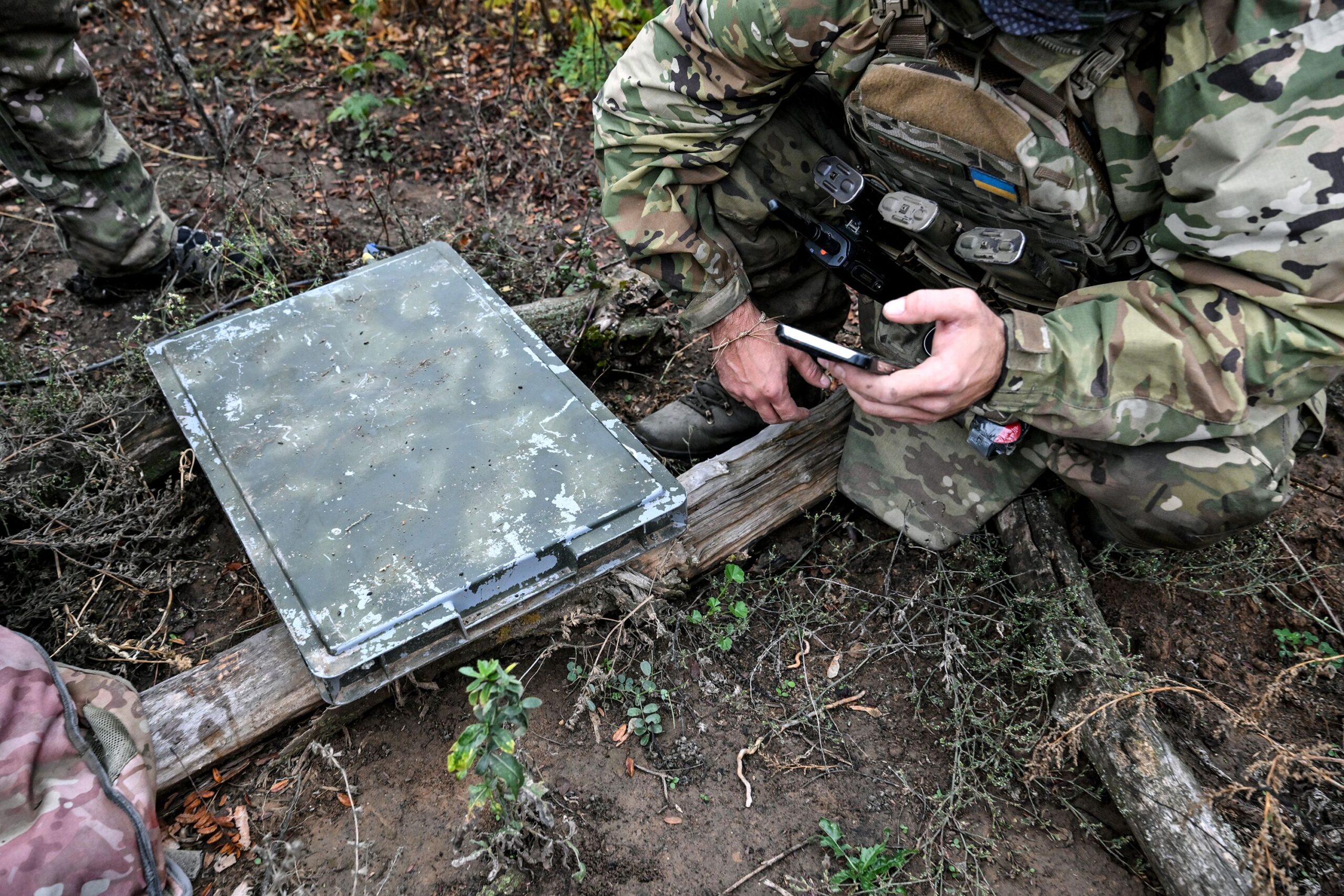 <i>Dmytro Smolienko/Ukrinform/NurPhoto/Getty Images via CNN Newsource</i><br/>A soldier uses a smartphone to check signal quality while setting up a Starlink satellite communication network in the Donetsk region
