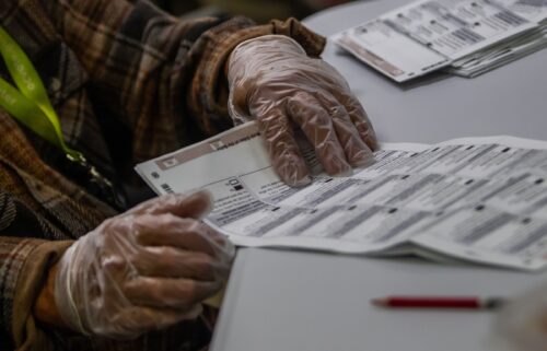 An election worker handles ballots at the Orange County Registrar of Voters Facility on October 28