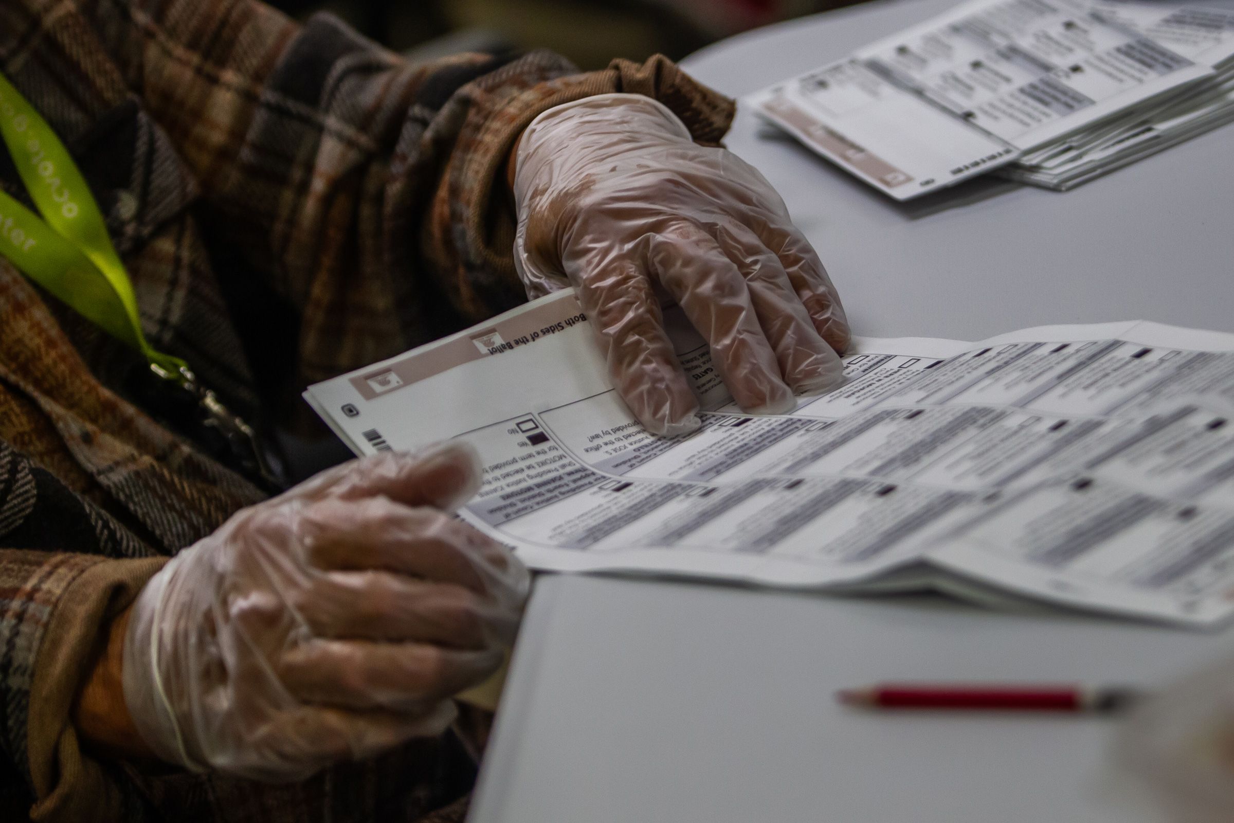 <i>Apu Gomes/Getty Images via CNN Newsource</i><br/>An election worker handles ballots at the Orange County Registrar of Voters Facility on October 28